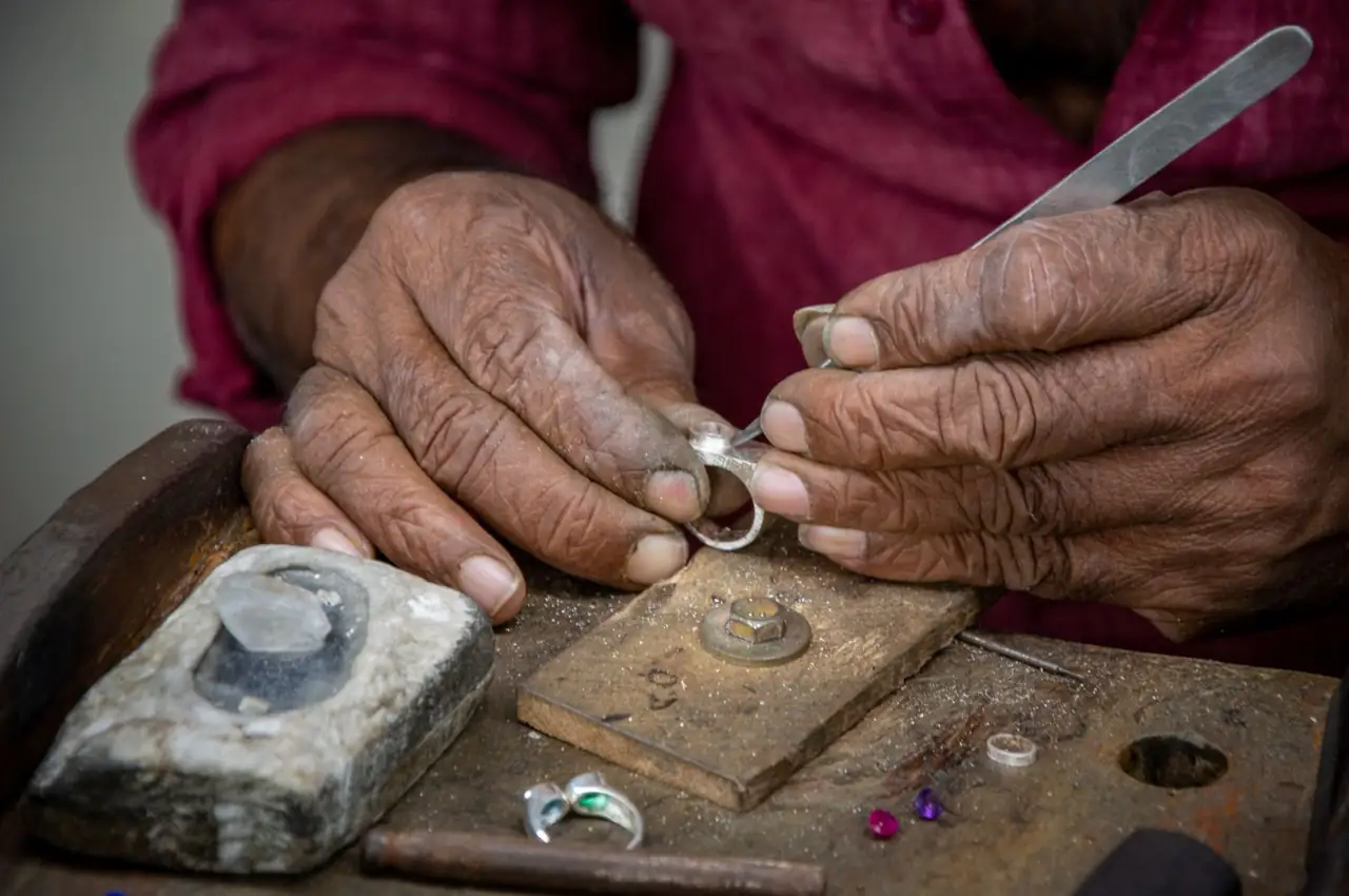 Artisan crafting a ring at the bench