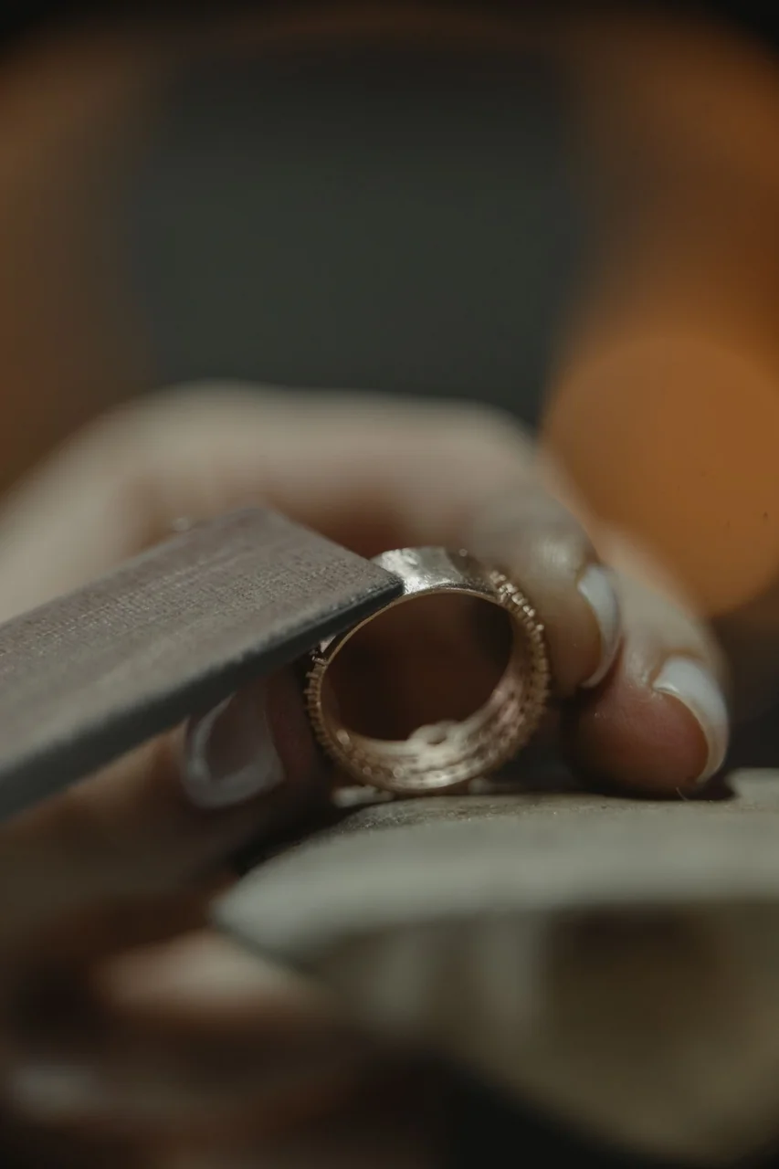 Artisan polishing a precious metal ring