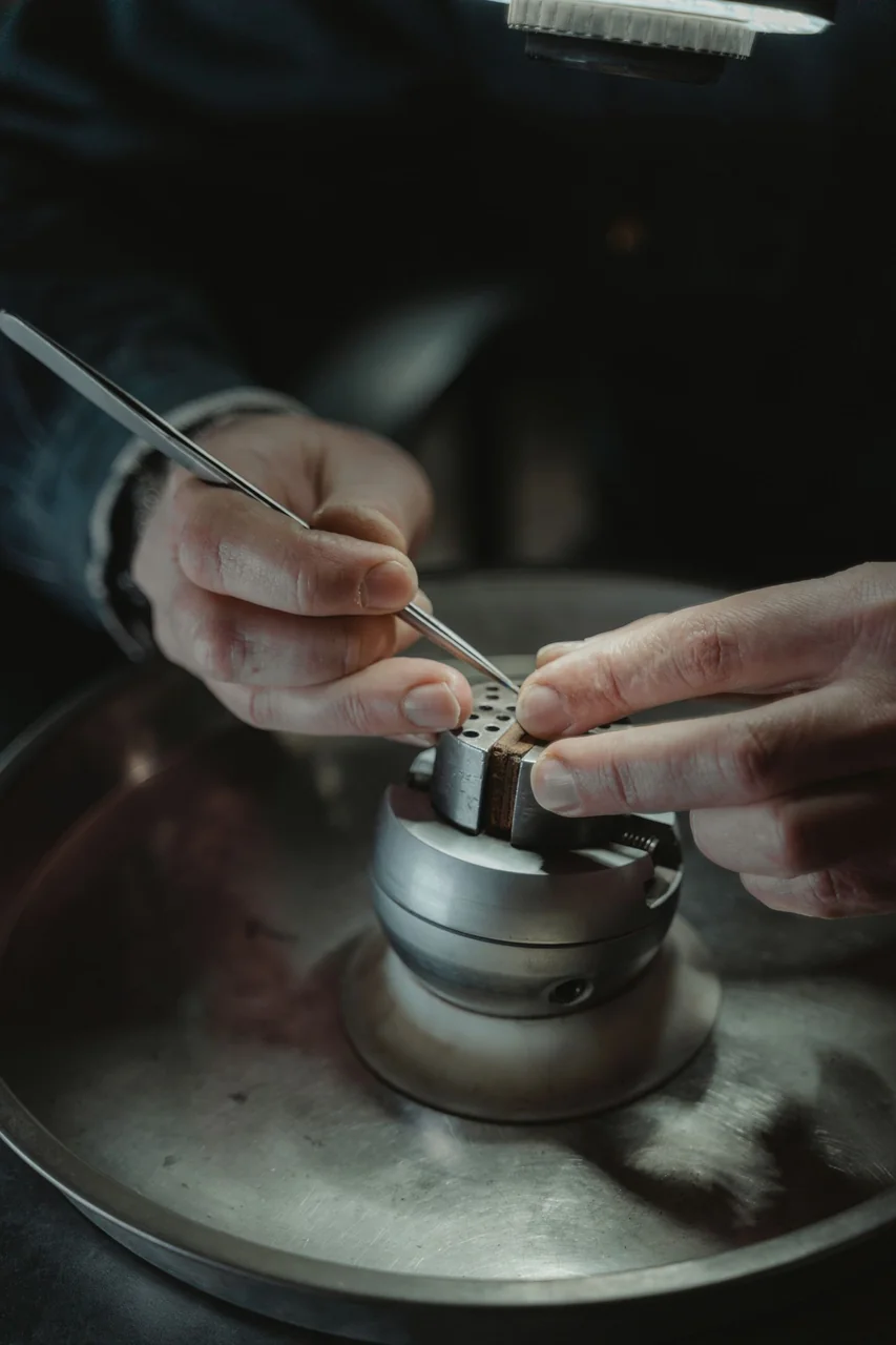 Detail of artisan hands using precision tools